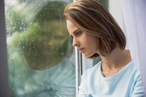 woman looking out window experiencing xanax withdrawal