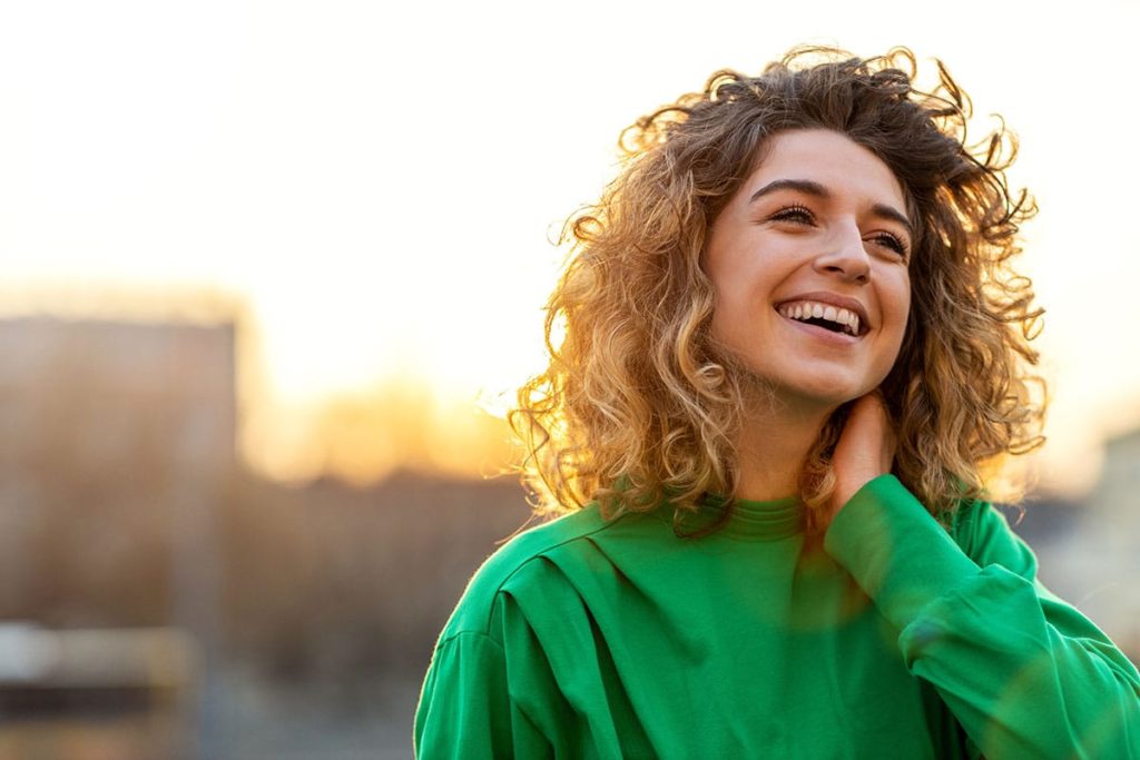 woman smiling and thinking about relapse prevention techniques