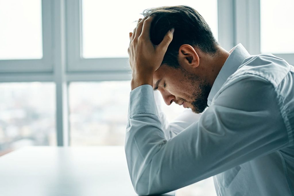 man having difficulty concentrating is experiencing common anxiety triggers