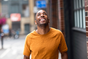 a man walking outside happily looking up and thankful for his decision on choosing sober living
