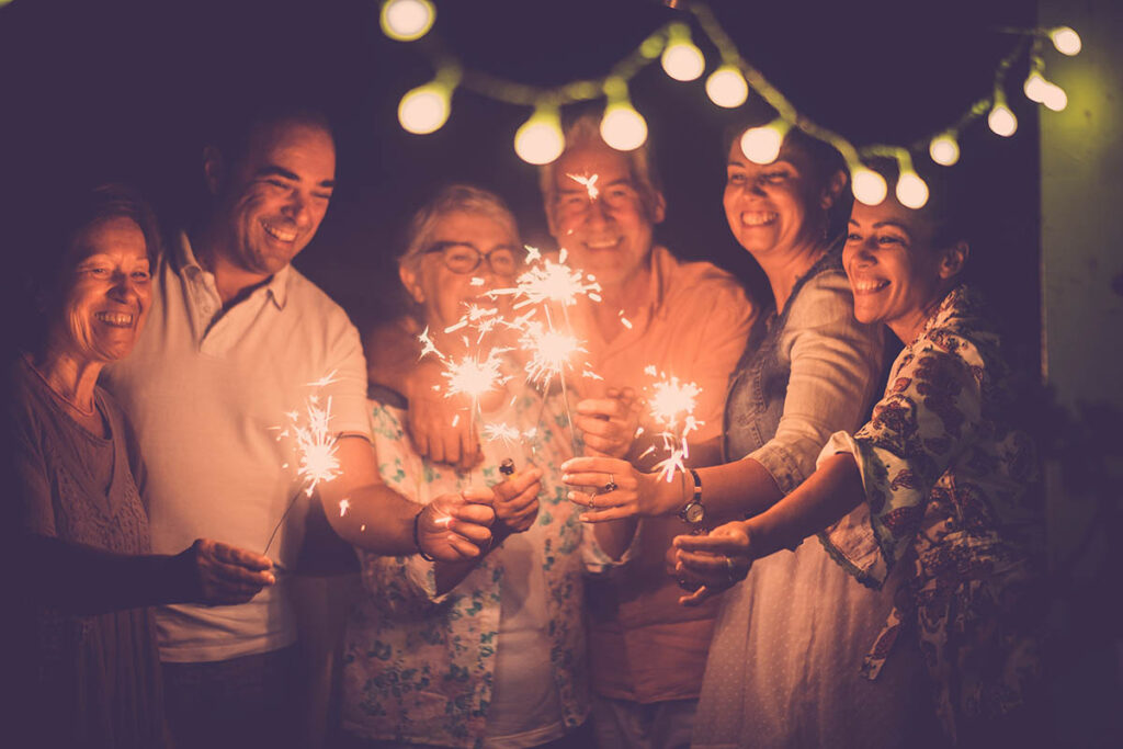 a group of people are gathered together and holding sparklers together while celebrating a sober new years