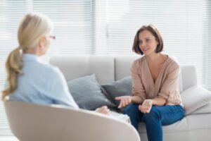a female patient talks to her therapist in her xanax addiction treatment program